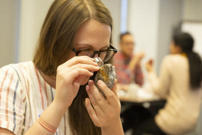 Teacher looking at Meteorite with Magnifier