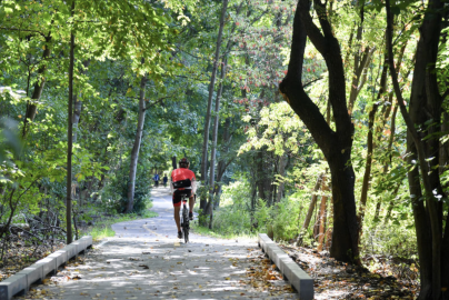 A person rides a bike through Van Cortlandt Park